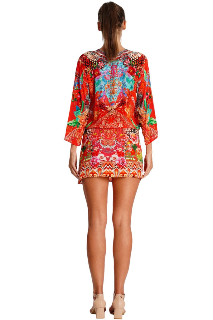 Wholesale red and orange ornamental print V-neck tunic mini dress with drawstring waist for resort boutiques - La Moda Clothing