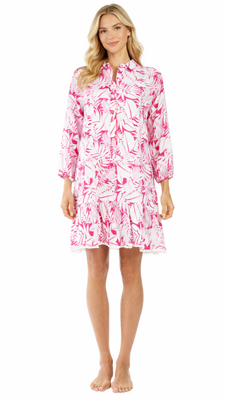 Woman wearing a pink and white patterned dress on a white background