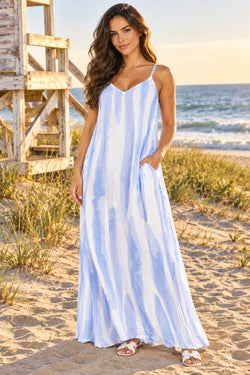 Luxury blue and white tie-dye maxi dress with spaghetti straps and pockets, front view on beach dunes - La Moda wholesale resort wear